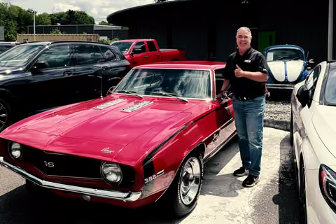 Customer with his red 1969 Chevrolet Camaro SS at Buonauto Enterprises